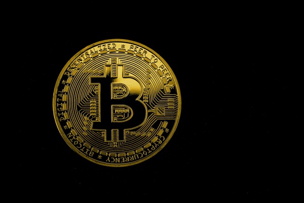 Gold Bitcoin cryptocurrency coin on a dark background