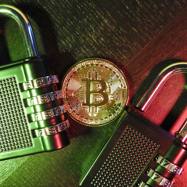 Bitcoin coin between combination padlocks symbolizing deposit security