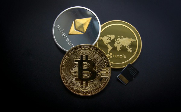 Ethereum, Ripple and Bitcoin cryptocurrency coins on a dark background