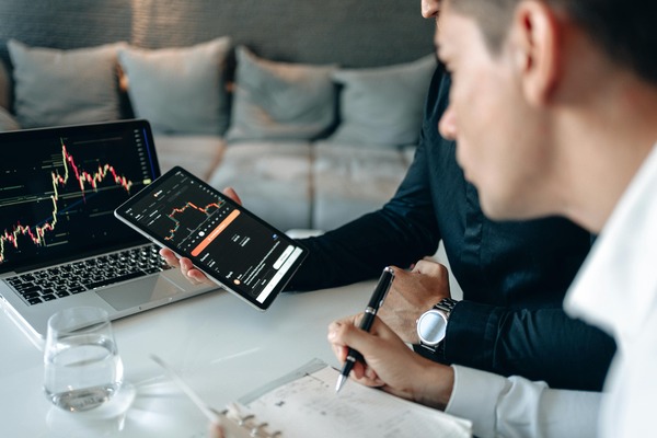 Crypto portfolio price chart displayed on a tablet and laptop