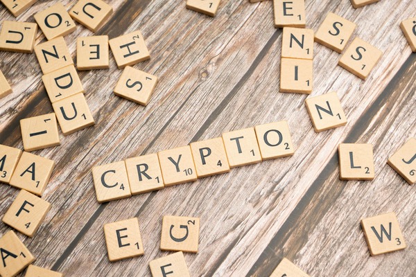 Wooden tiles spelling CRYPTO on a rustic wooden surface