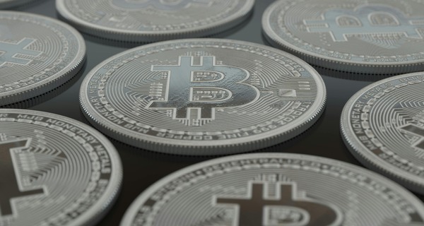 Close-up of stacked silver cryptocurrency coins
